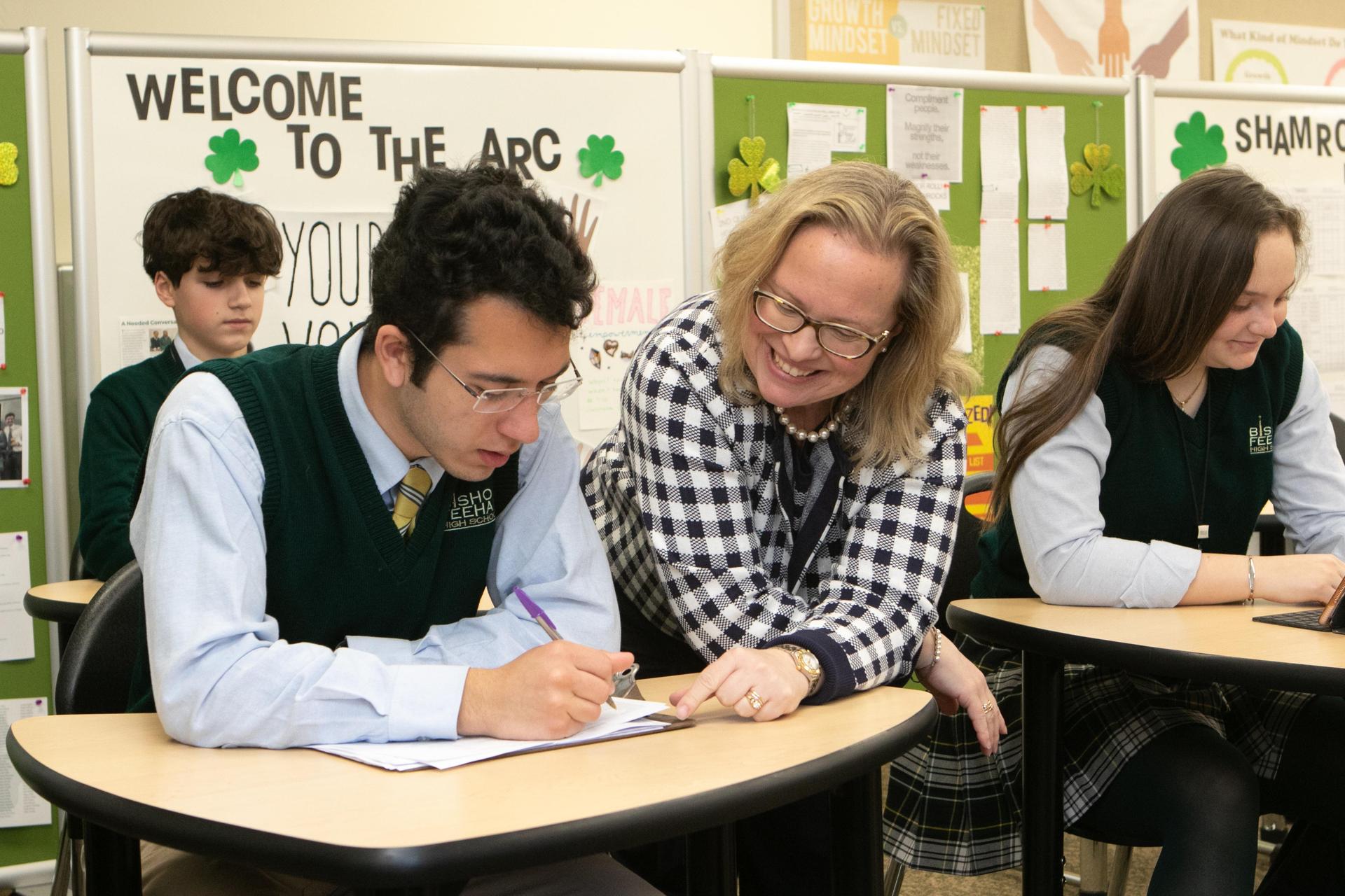 teacher helping student