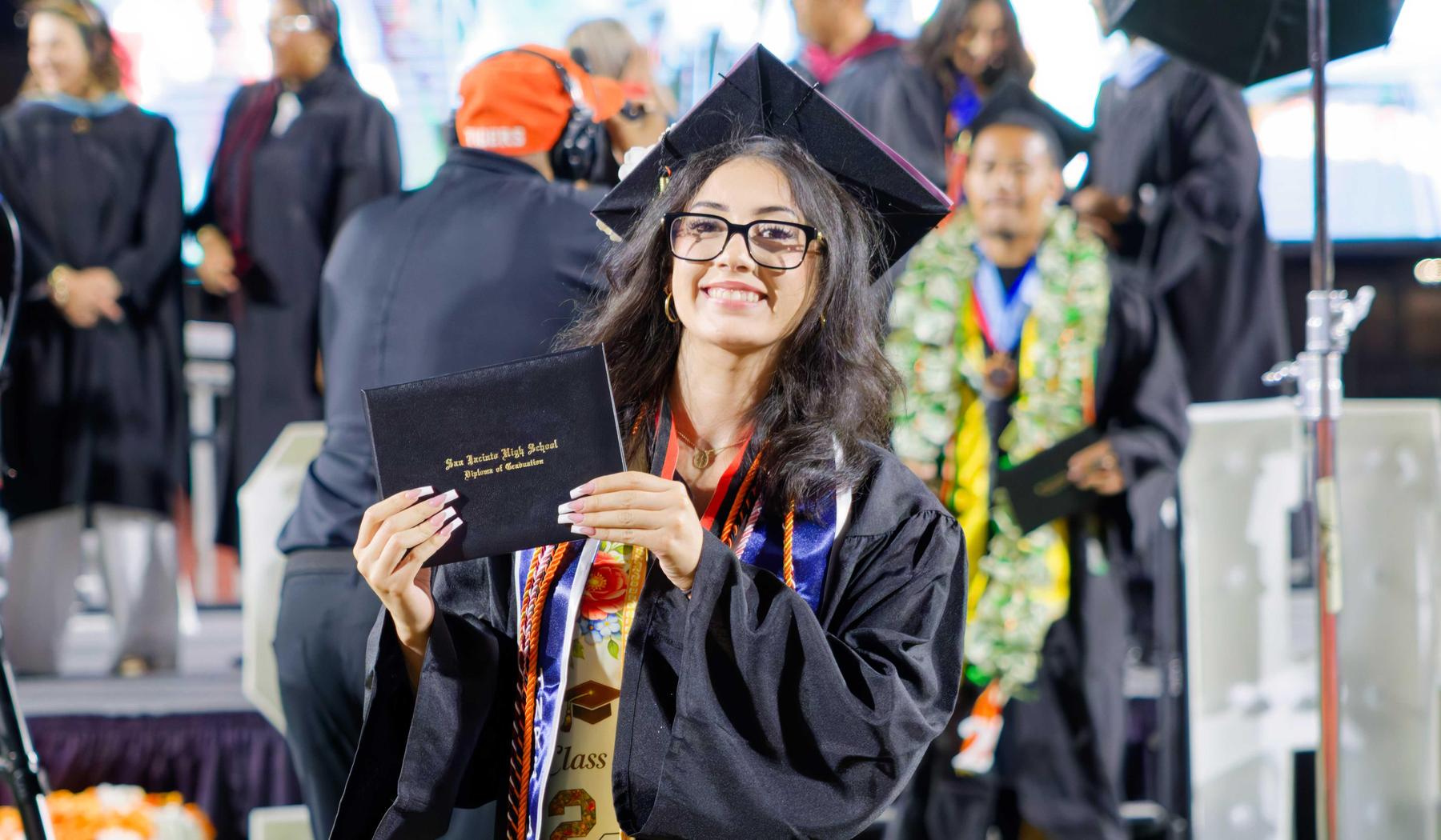 smiling SJHS graduate with diploma