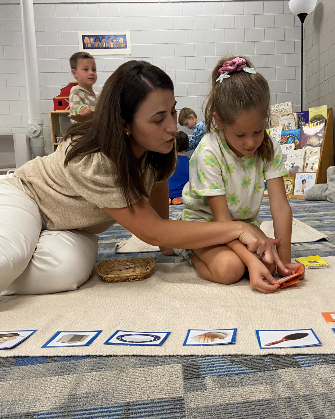 Montessori teacher works with student