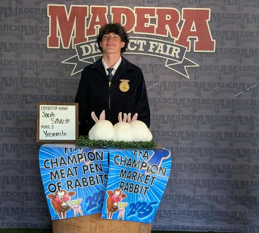 picture of FFA student winning prize for his rabbits at the Madera Fair