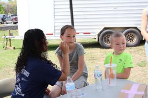 Little girl gets her face painted at the Ag Fair