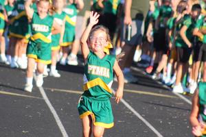 Tomahawk cheerleader and 1st-grader, Hannah Kaninberg, waves to spectators