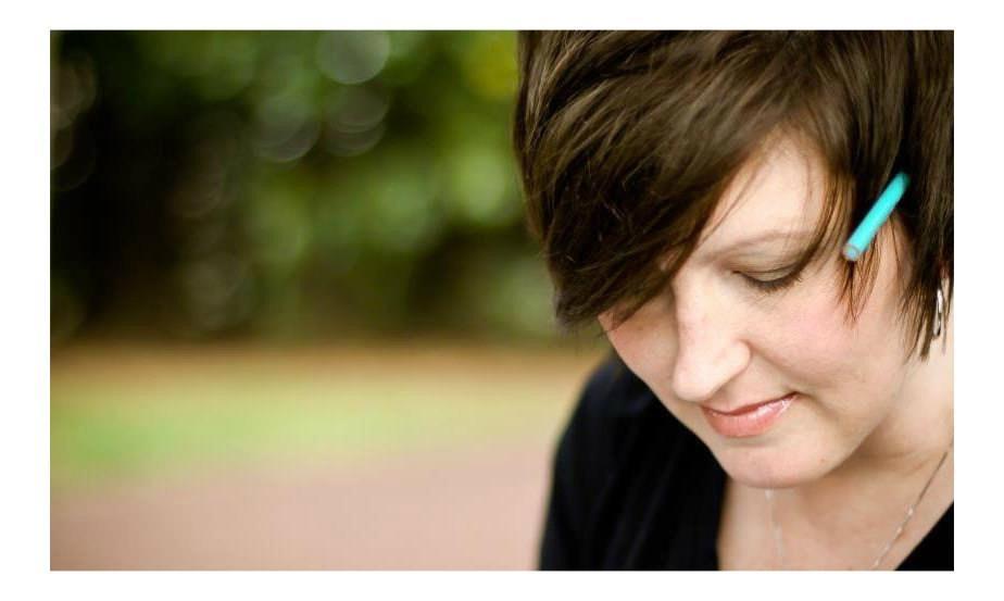 Art Teacher, Lisa Clements, with brown hair and black shirt, pencil behind her ear