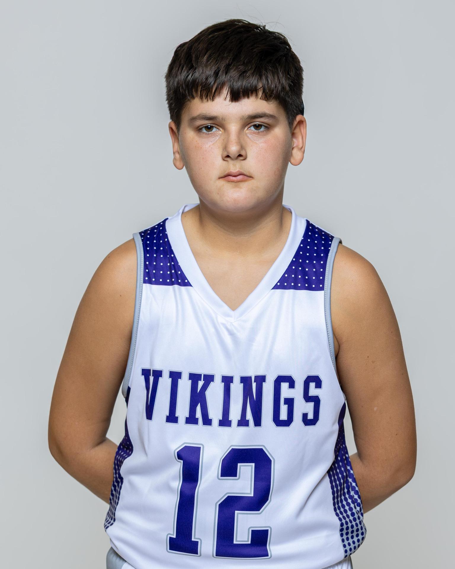 Male player number 12 posing with serious stature for a picture