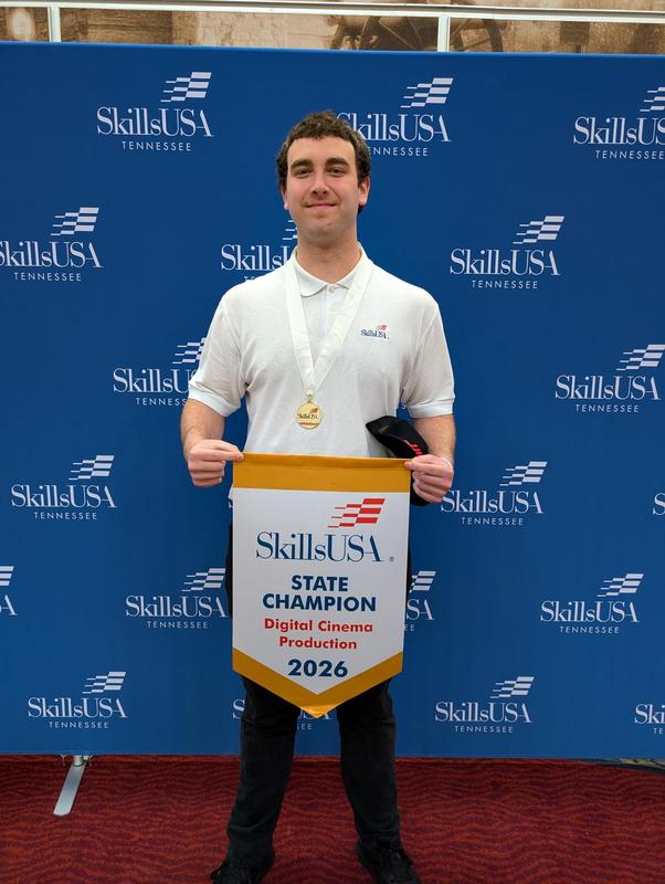 Smiling students with awards
