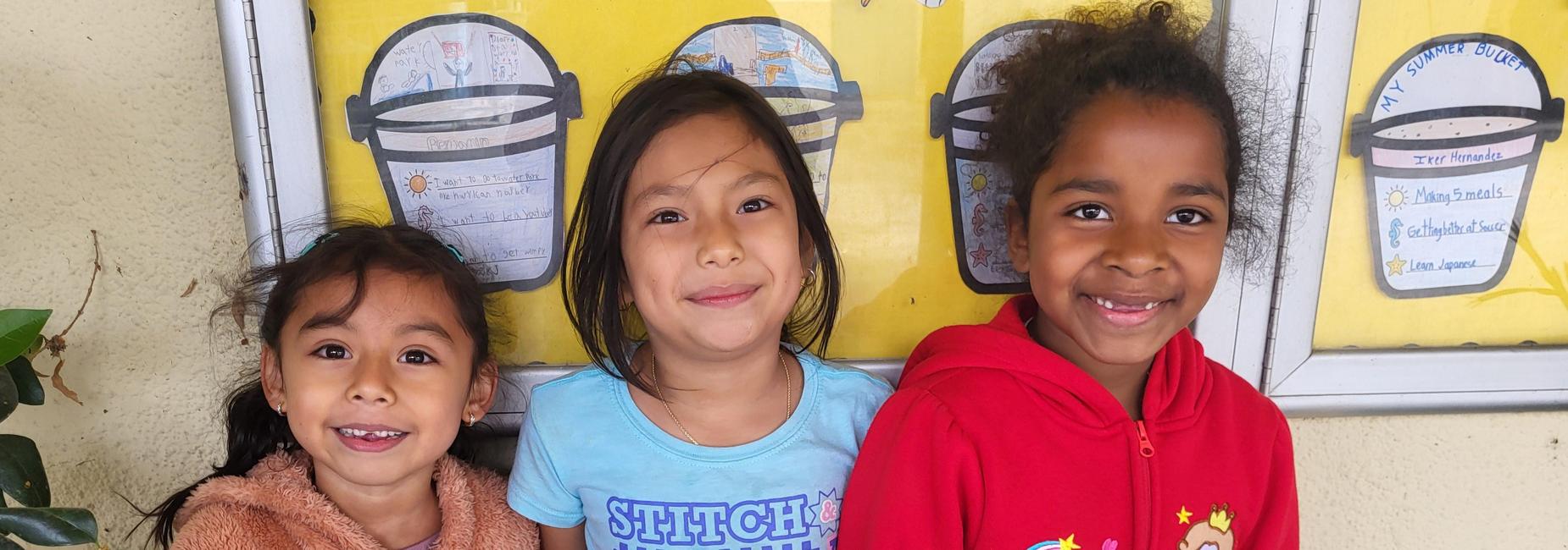 Three girls smiling