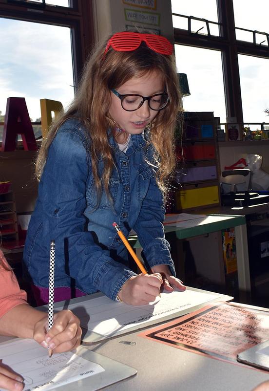 Students completing reading and math activities.