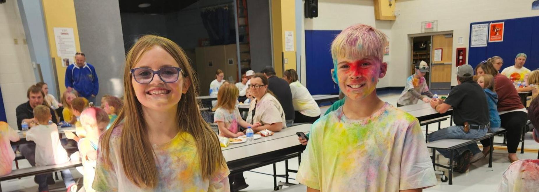 Students covered in chalk after color run