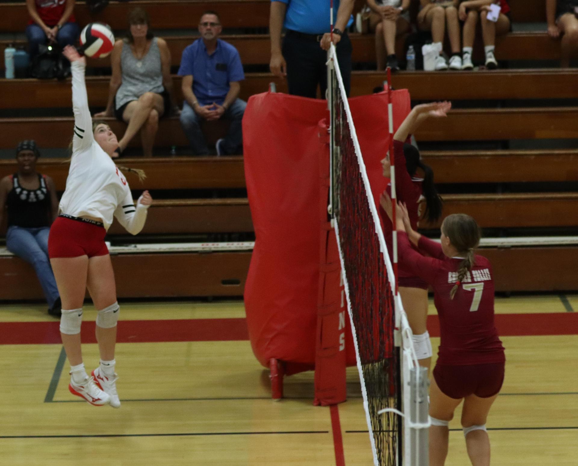 varsity volleyball players in action against golden valley