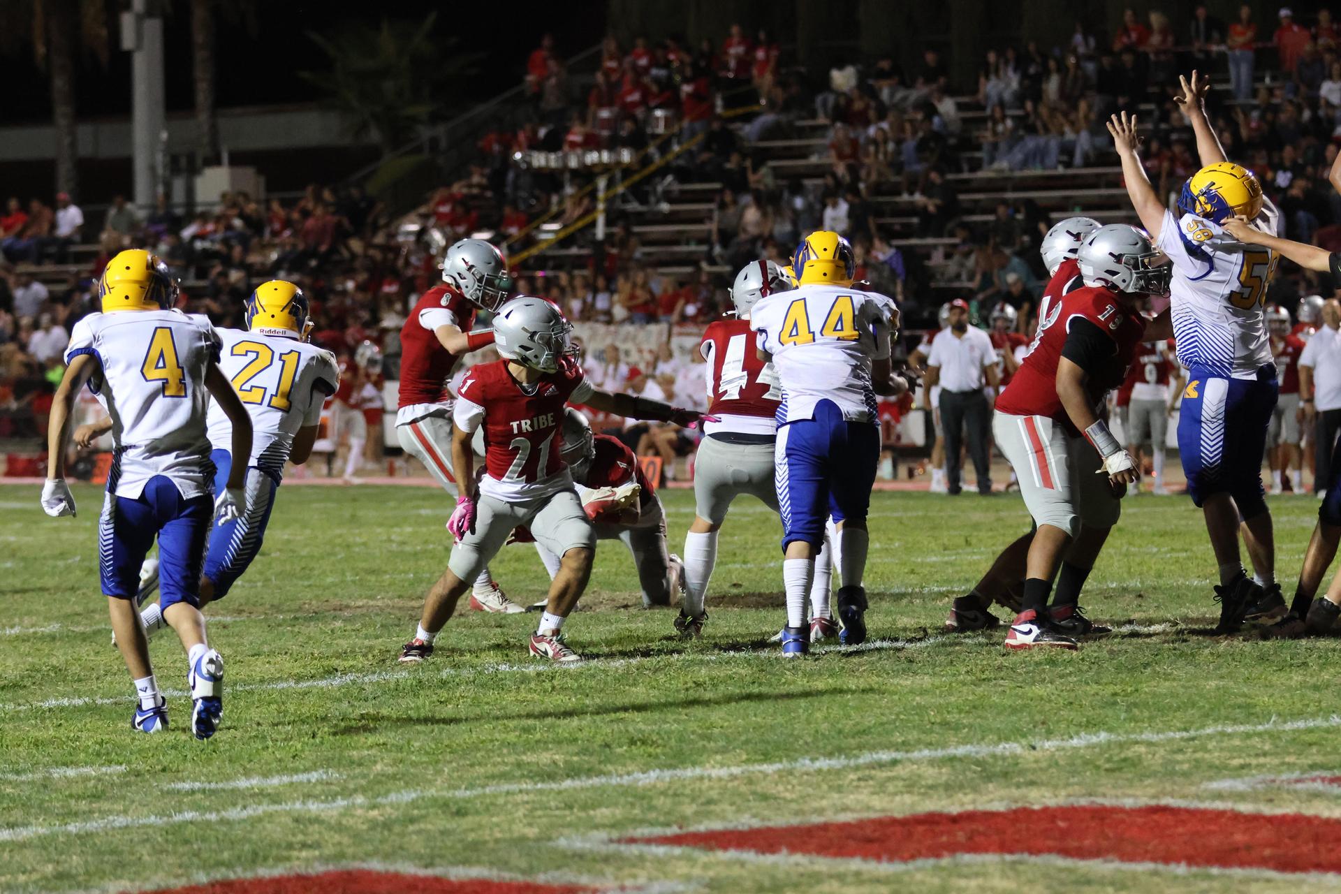 Varsity football players in action against Parlier 123