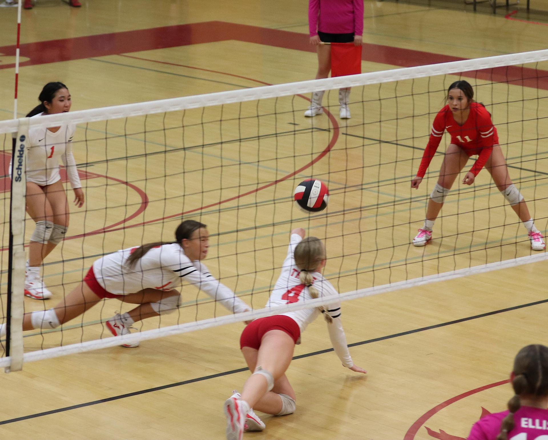 varsity volleyball players in action against Minarets
