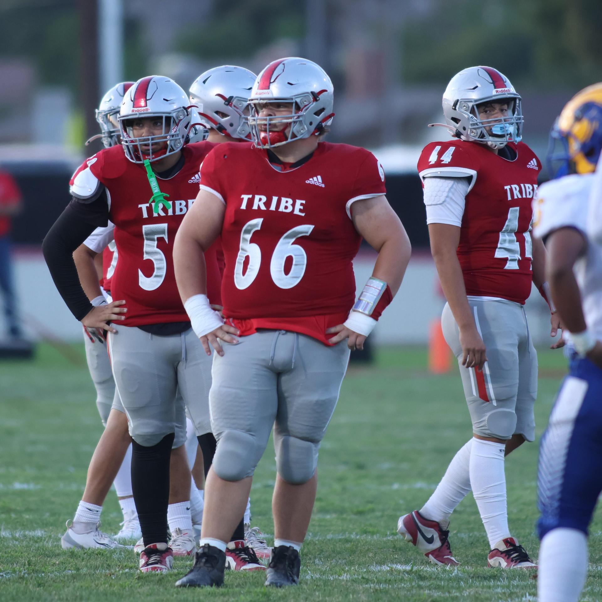 Varsity football players in action against Parlier 131