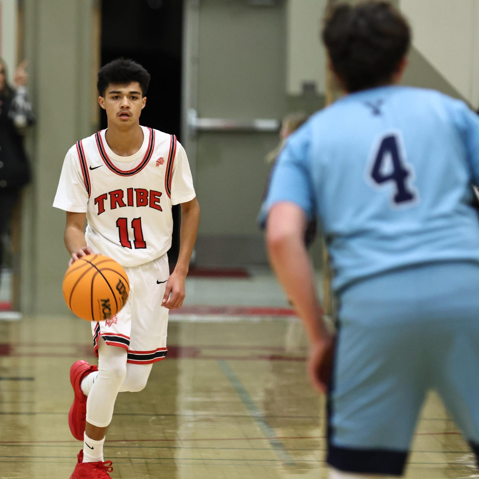 Varsity boys playing basketball against yosemite