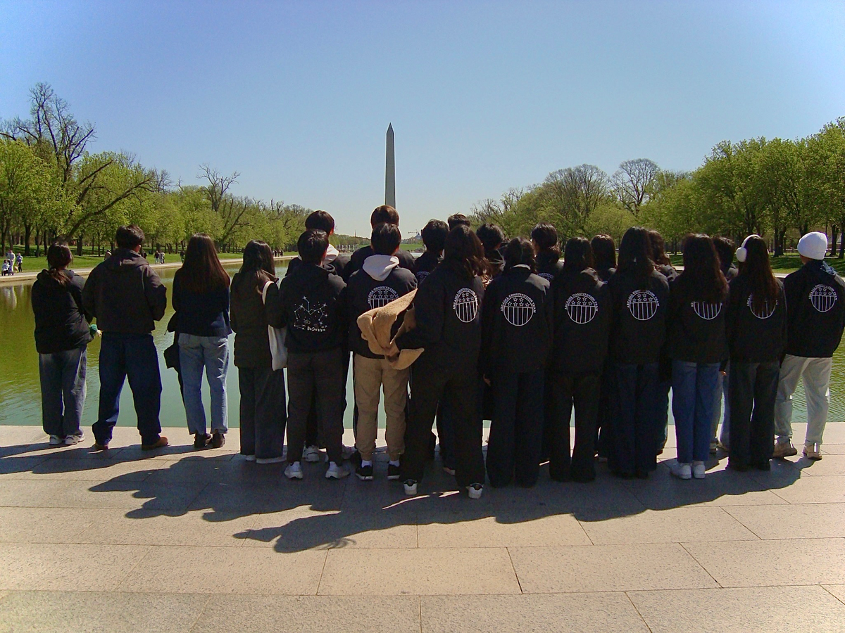 The Team Taking in a View of the Washington Monument 