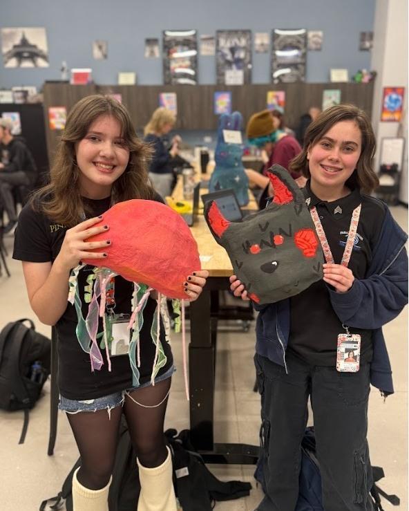 photo of students holding sculptures