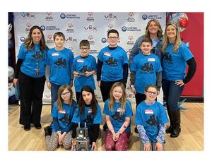 a group of students and teachers wearing blue t-shirts