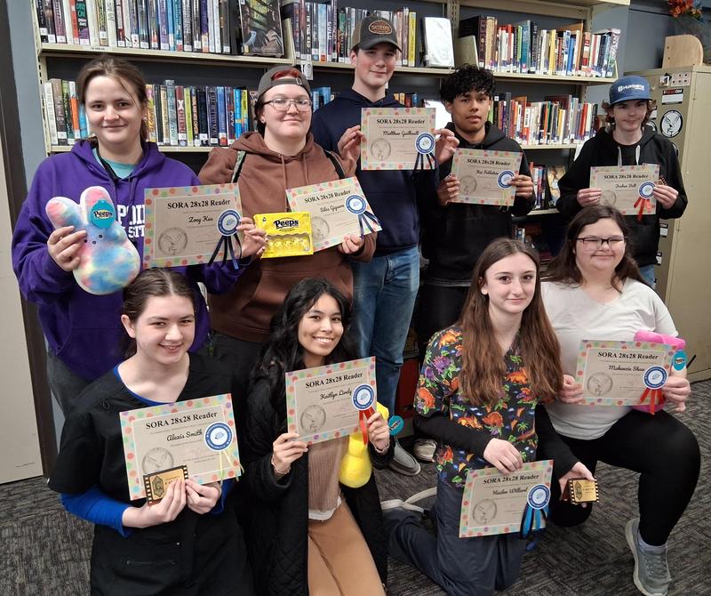 Students who completed Sora Reading Challenge gather in FCTS Library