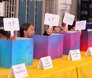 Students holding up signs with handwritten Chinese text