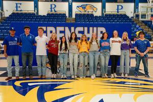 athletic signing students standing together