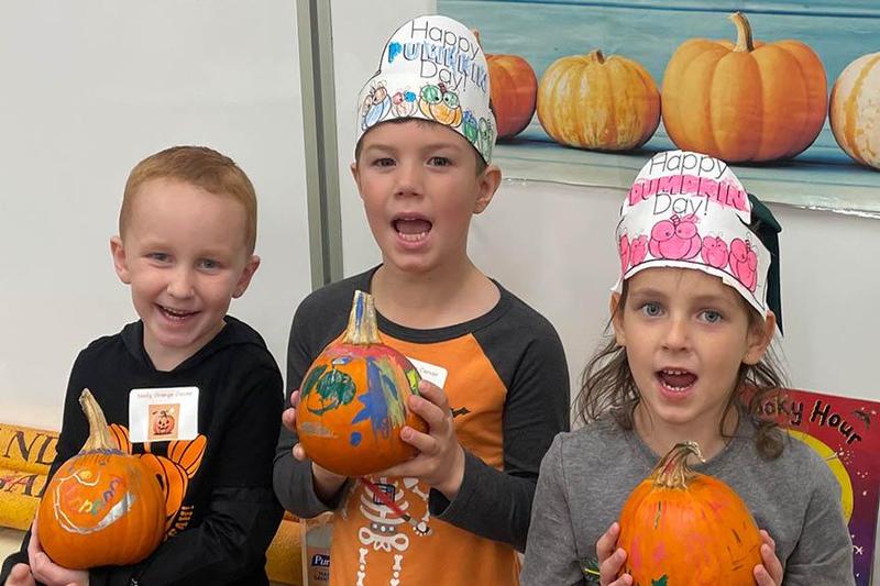 Nolan Rapach, Ty Wallace and Cyrina Corrao with their painted pumpkins