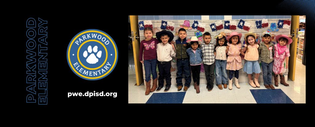 Group of children dressed in festive clothes, standing in front of a decorated wall.