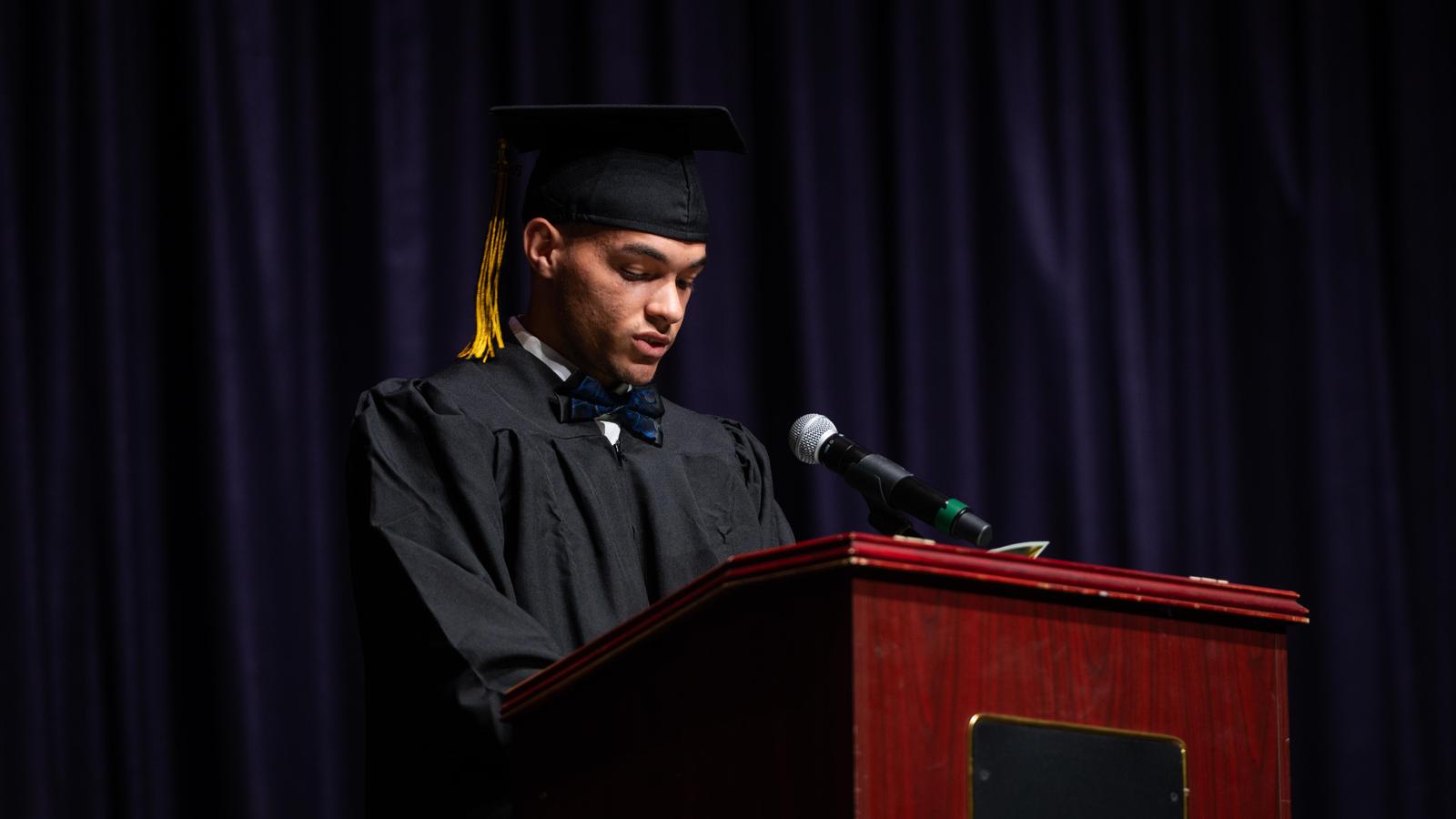 Graduate speaking at a podium