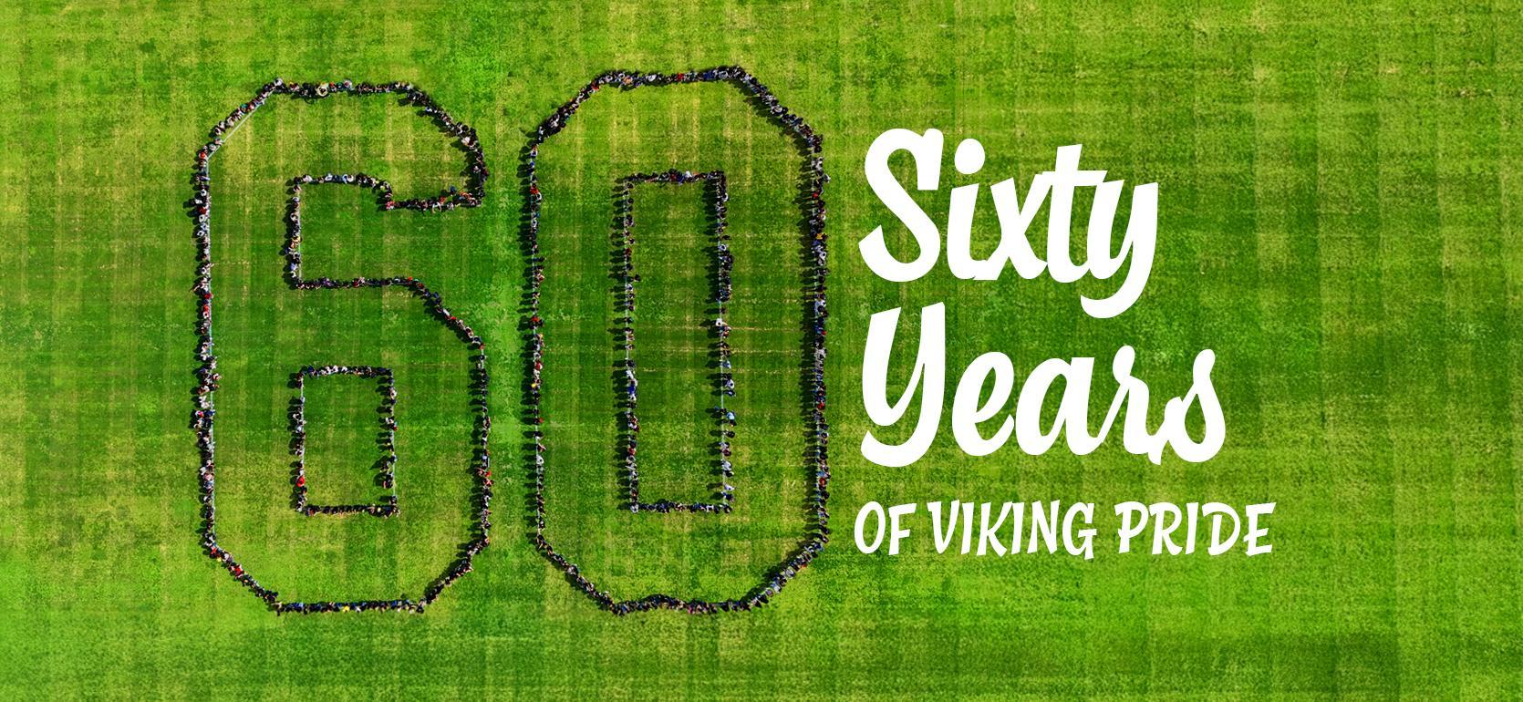 Large group forming the number 60 on a green field with text celebrating 60 years.
