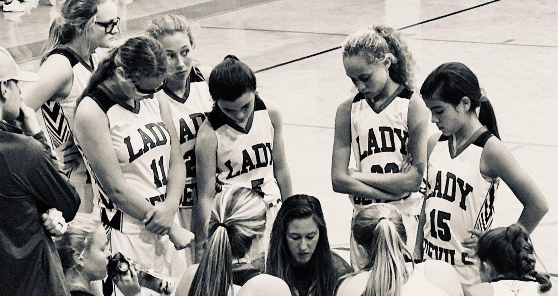 picture of girls basketball team and coach