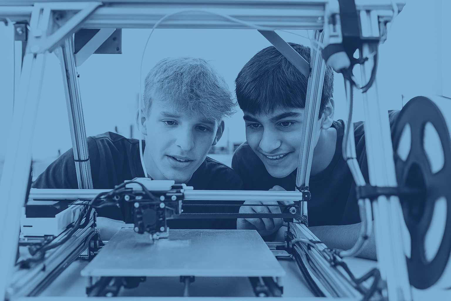 students observing a 3d printer