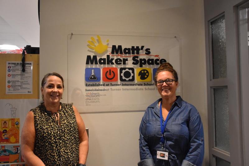 Principal Kerry and Assistant Principal Jeanette in front of Maker Space sign
