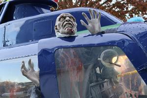 Airplane decorated with skeleton outside of hangar