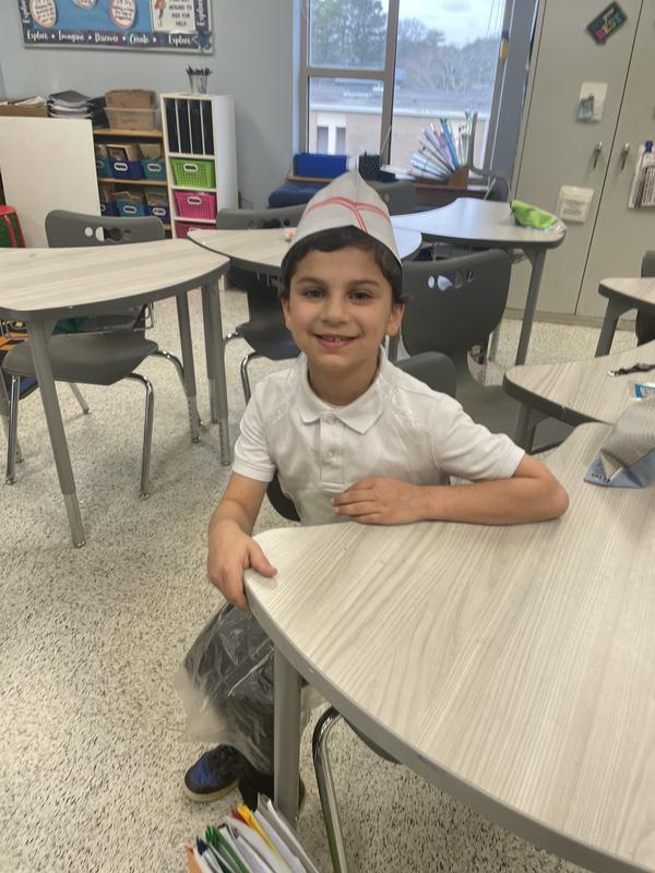 a boy poses during the math bakery.