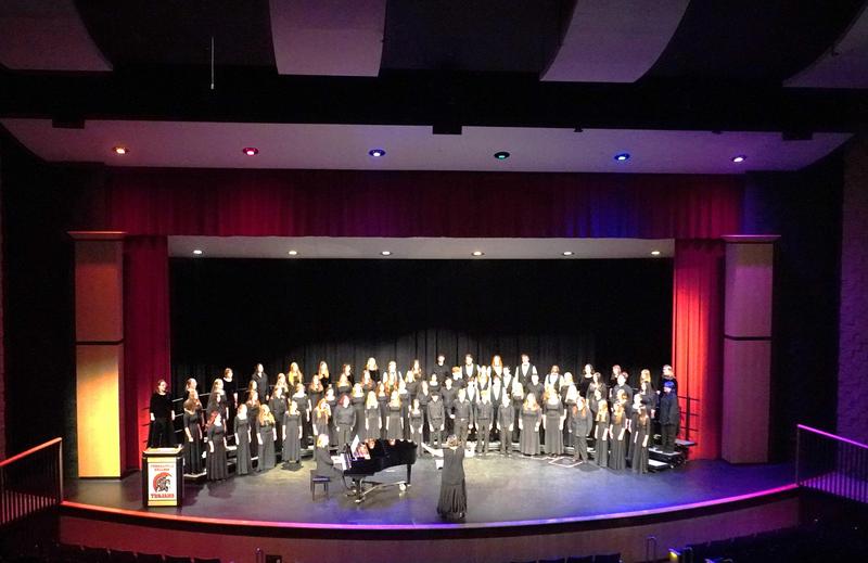 The combined TKHS Concert and Honors choirs perform together.