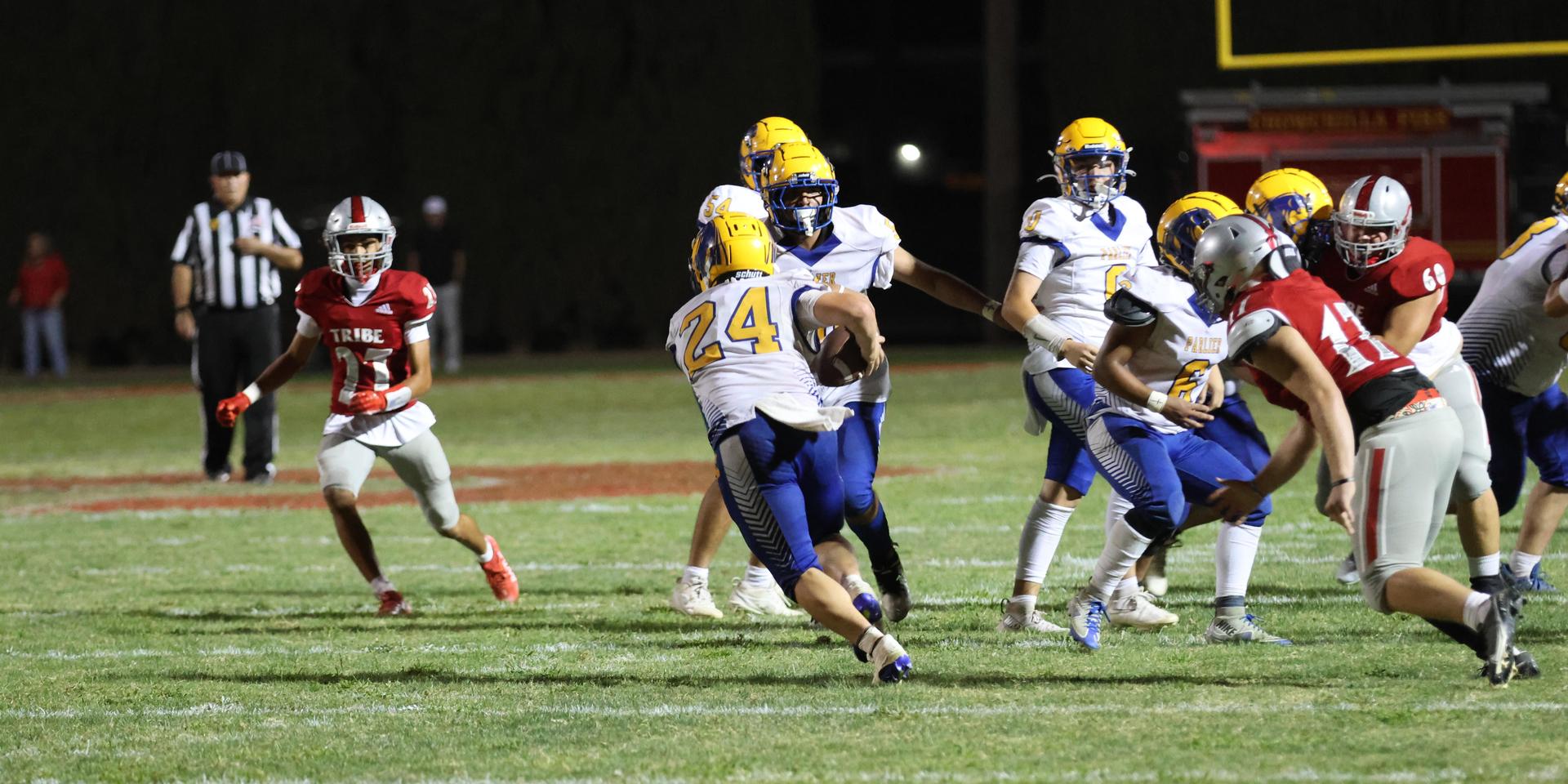 Varsity football players in action against Parlier 98