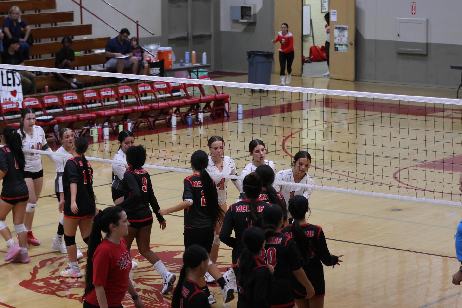 junior varsity girls playing volleyball 135