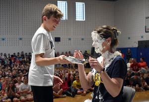 a student throwing a pie in a teacher's face