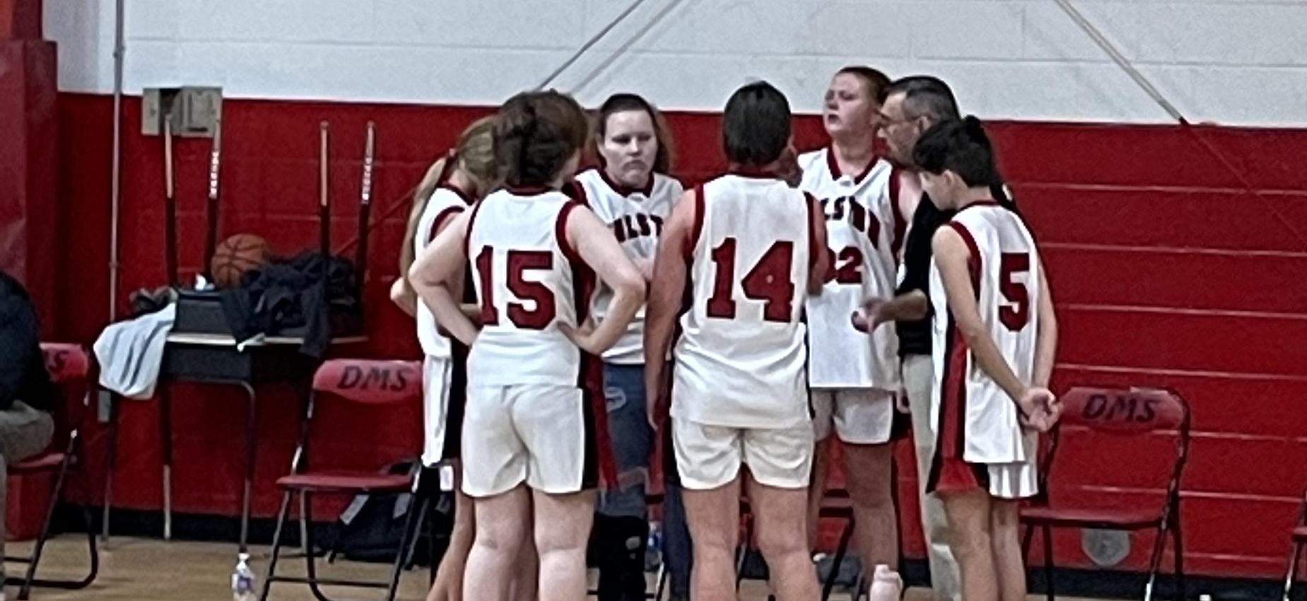 A coach talks to his basketball players.