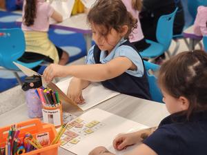A student practicing word construction on her word board