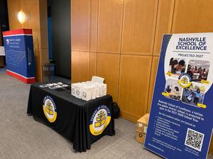 Nashville School of Excellence's exhibit booth featuring school information, promotional materials, and a banner at the 2026 National Civics Bee.