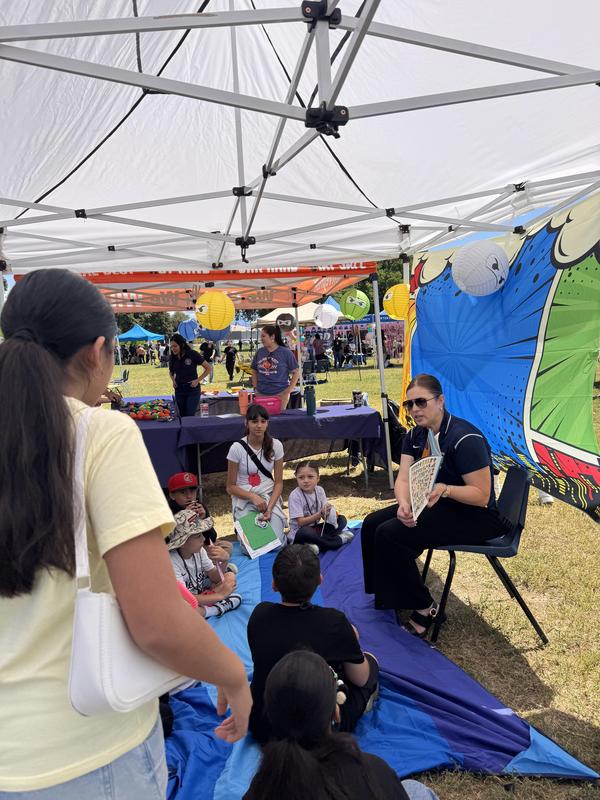 Ms. Gutierrez reading to a group of students