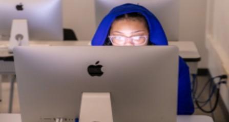 student behind computer screen