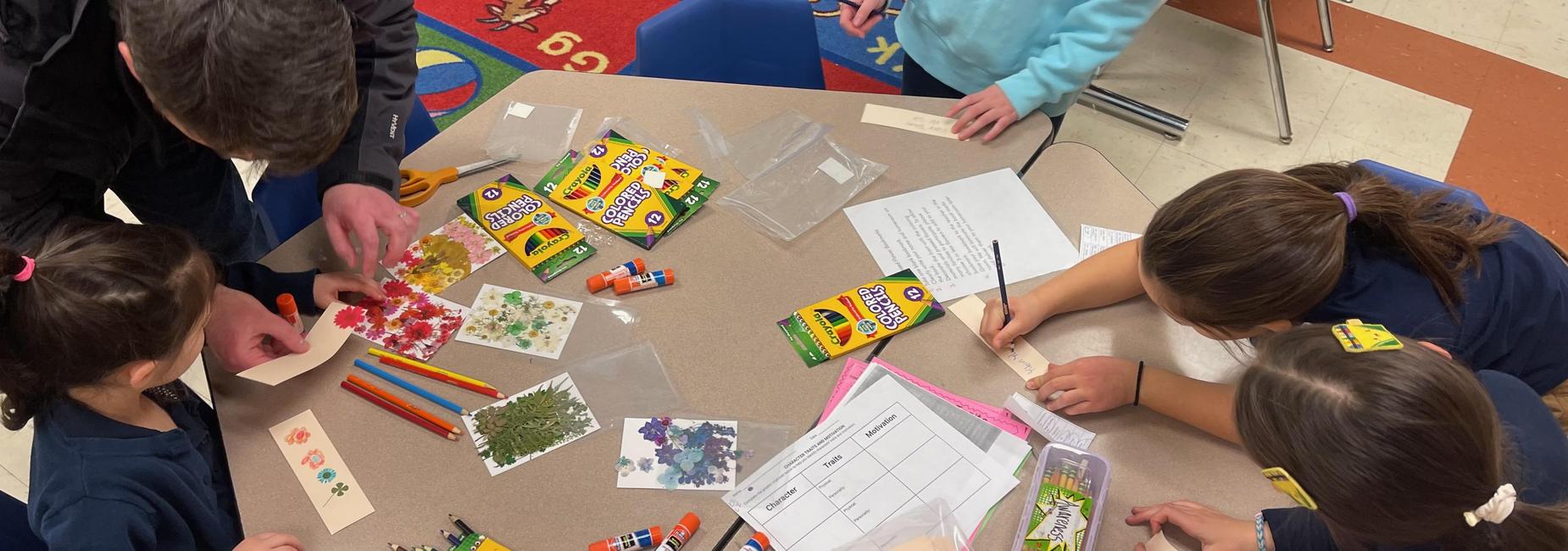 Family STEM Night 2026, students are creating bookmarks using leaves and decorating them with markers.
