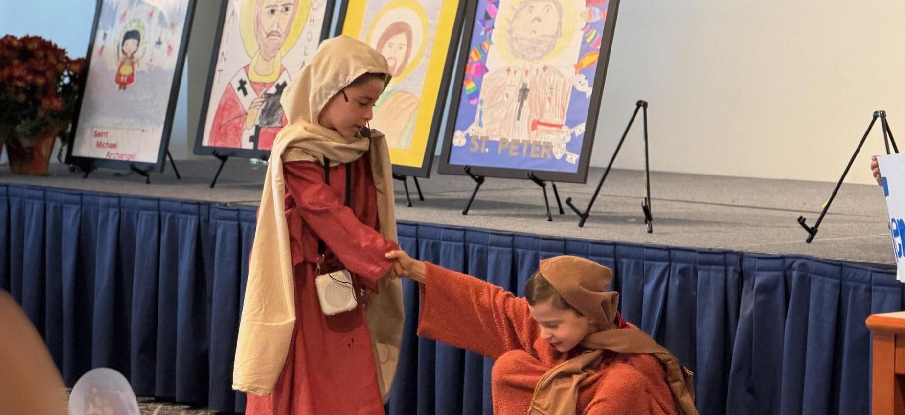 2nd grade students act out a scene from St. Peter's life
