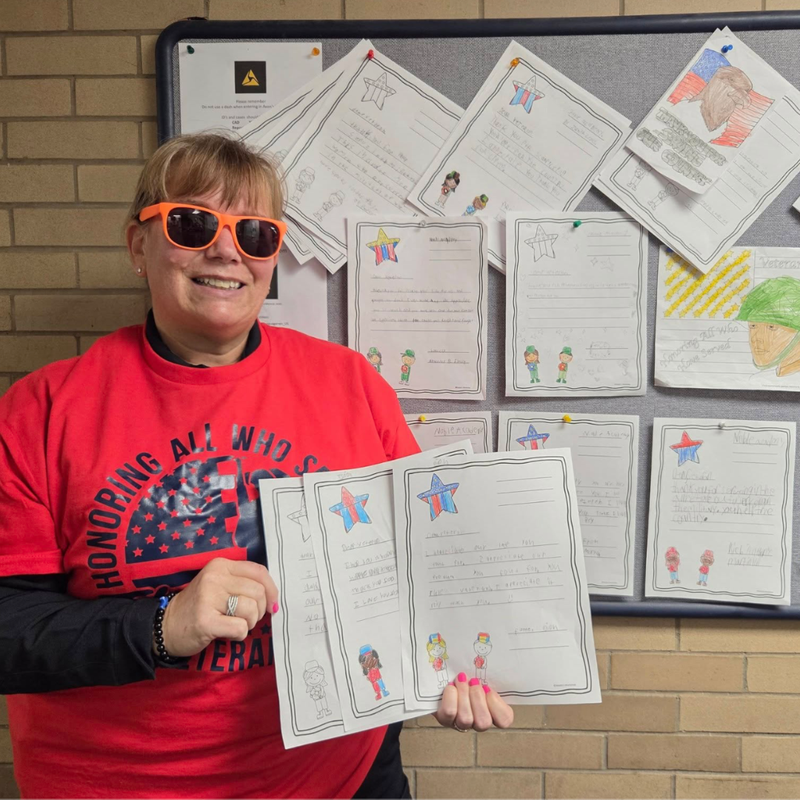 Police officier holds up letters from Noble Columbus students