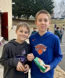 Two JRDS middle school students enjoy a snack during mid-morning break.