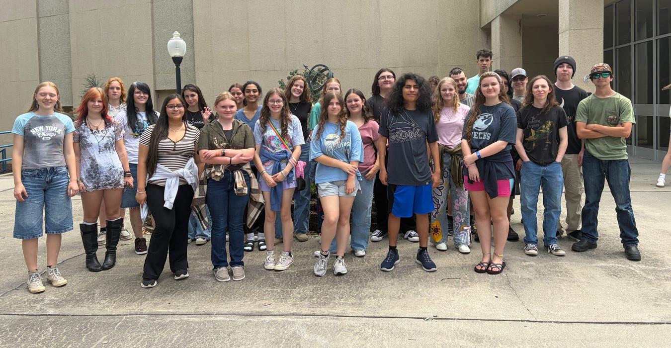 Group of students posing outside a building.