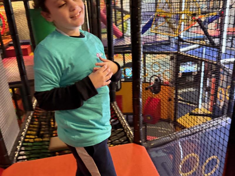 Student playing in a climbing structure