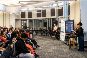 Students listen to the guest speakers in the library