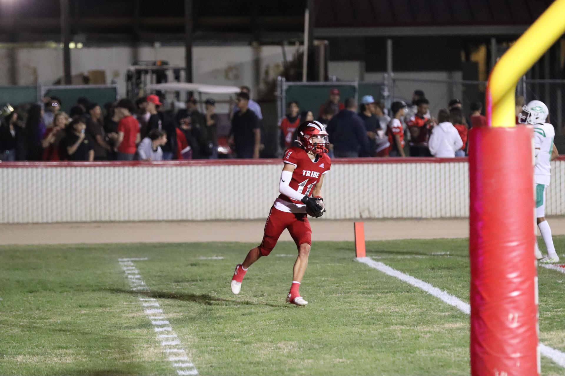 varsity football players in action against Riverdale