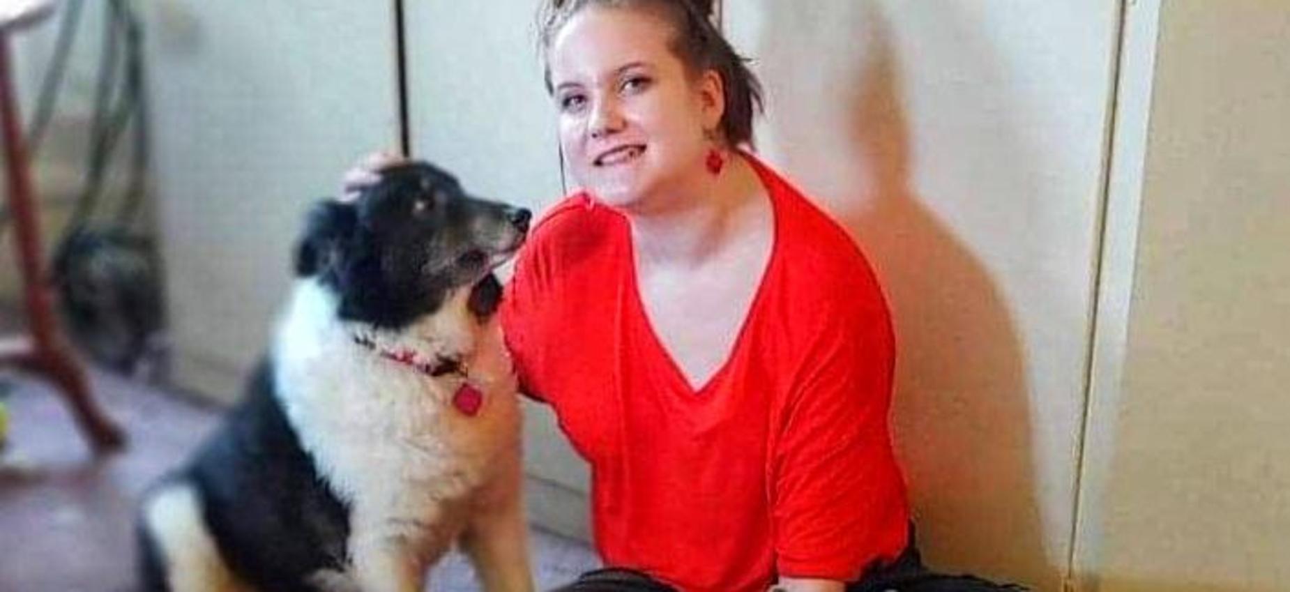 A student pets a dog.